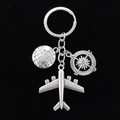 Silver metal travel keychain set with earth, compass, and airplane pendants on black background - Globe Compass Airplane Style (3# Large Airplane)
