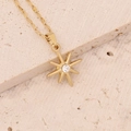 Macro view of gold octagonal star pendant with a sparkling round clear gemstone - Octagonal Star Clear Gemstone Style (9#)
