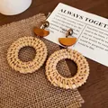 Detail of bohemian round straw woven earrings with wooden accents and gold studs - 21# Steel Pin - Coffee (Woven Wood Rattan Hoop Style)