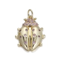 Detailed close-up of a beetle pendant in gold metal with pink gemstone inlays - Ladybug/YSN088-12