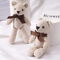 Pair of beige knitted teddy bear plush charms with dark brown ribbon bows - Milky White