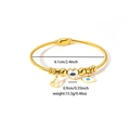 Detail of gold evil eye and heart charms on a stainless steel cable cuff bracelet - Hollow Heart and Long Evil Eye Style (TYGB0160)