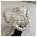 Detailed shot of cream white quilted cloud bag featuring a fluffy handle and gold chain strap - White