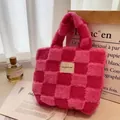 Pink and beige waffle checkerboard faux fur bucket bag with brand label on surface - Rose Pink