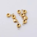 Detailed macro shot of eight golden stainless steel birthstone charm settings for DIY jewelry - Gold Single Loop