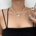 Elegant pearl choker necklace featuring a white rose pendant on a female model - Rose Flower Irregular Artificial Pearl Necklace (DX0239) / White