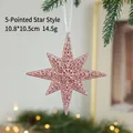 Rose gold glittery star Christmas ornament hanging on a festive pine tree branch - Exploding Star B