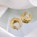 Macro shot of gold-plated twisted hoop earrings on silk fabric with reflective finish - Gold Twisted Texture Hoop