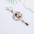 Close-up of leopard silicone ring, brown cow pendant, and tassel on decorative plate - Leopard Print With Brown Calf (#3)