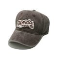 Close-up of Florida embroidery on vintage brown washed cotton baseball cap with frayed edges - Coffee