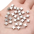 Detailed view of silver cross metal spacer beads for DIY jewelry making on a hand - Cross / 6x6mm