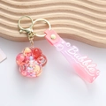 Porte-clés patte de chat rose avec sable mouvant liquide sur support en bois blanc - Rose