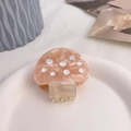 Close-up of a pink marble acetate mushroom hair claw clip on a white ceramic tray - Approx 4.5cm / Pink