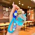 Detail of blue liquid glitter keychain with floral wristband and gold bell accessory - Strawberry Strap Blue Luminous Dried Flower Iceberg Cup