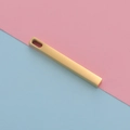 Close-up of a minimalist golden rectangular bar pendant with an oval top hole for DIY jewelry - Gold