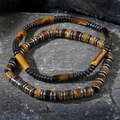 Men's Tiger Eye cylinder beaded bracelets with dark metallic spacers on rock surface - Tiger Eye Cylinder Metal Ring Bracelet Set (B-S24062901A)