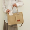 Minimalist beige canvas tote bag with front pockets and adjustable shoulder strap for women - Khaki