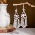 Close-up of ethnic silver peacock earrings with leaf hollow patterns and long tassels - Silver Hollow Floral Tassel(E2875-20)