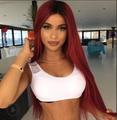 Long straight red wig with middle part styling, smooth synthetic fiber on fashion model - Burgundy