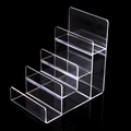 Transparent acrylic 4-tier ladder display stand for wallets and phones on black background - 4 Tiers / Clear