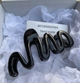 Glossy black wavy hair claw clip with a minimalist design in a gift packaging box - Black