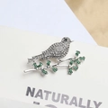 Silver alloy bird brooch with sparkling rhinestones and green enamel leaf details - Silver Bird on Branch (241)