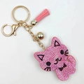 Pink rhinestone cat keychain with leather tassel and gold bell on a clean white background - Pink
