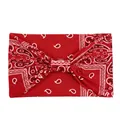 Close-up of red paisley bandana headband with twist knot detail on white background - Paisley Red