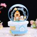 Blue Capybara rotating snow globe music box with brown capybara figure on a spa base - Large 100mm Snow + Light / Blue Base