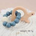 Blue silicone and beech wood baby teether bracelet with animal shaped wooden toy - Dinosaur/Blue Beads