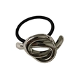 Detailed close-up of a silver knot alloy charm on a black elastic ponytail holder - Silver Knot