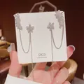 Macro detail of S925 silver long tassel earrings with flower crystal and leaf design - E0040 Silver Needle (Flower Leaf Tassel Silver)
