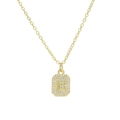 Macro detail of gold-plated pendant featuring letter E and sparkling pavé zircons - Necklace E