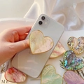 Detail showing heart-shaped phone grip with shell texture and golden plated edge - Gold Heart Grip / White Scallop Shell