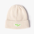 Cream white knitted beanie hat with fluorescent green embroidered patch for winter - White