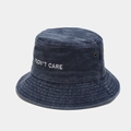 Detail of blue washed denim bucket hat with I DON'T CARE embroidery and metal eyelets - M (56-58cm) / Navy Blue