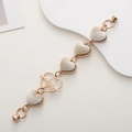 Golden heart link bracelet with beige plush inserts and magnetic clasp on white - Heart Beat / White