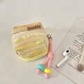 Detail of tweed woven mini storage pouch with zipper and beaded lanyard for earbuds - Yellow