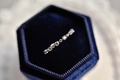 Macro view of slender sterling silver ring with micro-pave zircons in a velvet gift box - US 9 / Silver