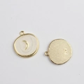 Macro detail of alloy star and moon pendant with white enamel and SW engraving - White Shell Moon