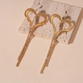 Detail of gold heart earrings with long crystal tassel fringe on a natural stone base - Large Heart Tassel Style / Gold