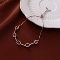 Detail of silver adjustable bracelet with oval red gemstones and micro-pave crystals - Silver Tone Red Oval Adjustable Slider Style