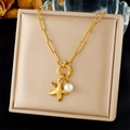 Detail of gold-plated starfish and pearl charms on a necklace displayed on a beige stand - Starfish And Pearl Double Pendant (N3478)