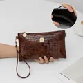 Elegant brown bamboo pattern clutch bag featuring crystal hardware and wrist strap - Dark Brown