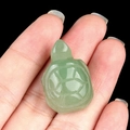 Green aventurine carved turtle figurine in hand with translucent gemstone details - Green Aventurine