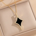 Golden geometric star necklace with black inlay and crystals in a beige jewelry box - Black Shell Necklace (840)