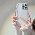 Close-up of a purple wavy edge phone case for iPhone with a soft white back panel design - iPhone 14 Pro Max / Purple