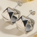 Macro shot of silver geometric square stud earrings with polished metallic finish - Silver Rhombus Geometric Stud Earrings