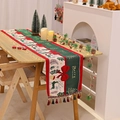 Detailed view of Christmas table runner with festive deer prints and decorative tassels - 120CM*35 / Bowknot Style