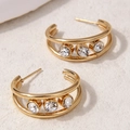 Detailed macro view of gold C-shape hoop earrings with double-layered lines and three crystals - Double Layer with Three Stones